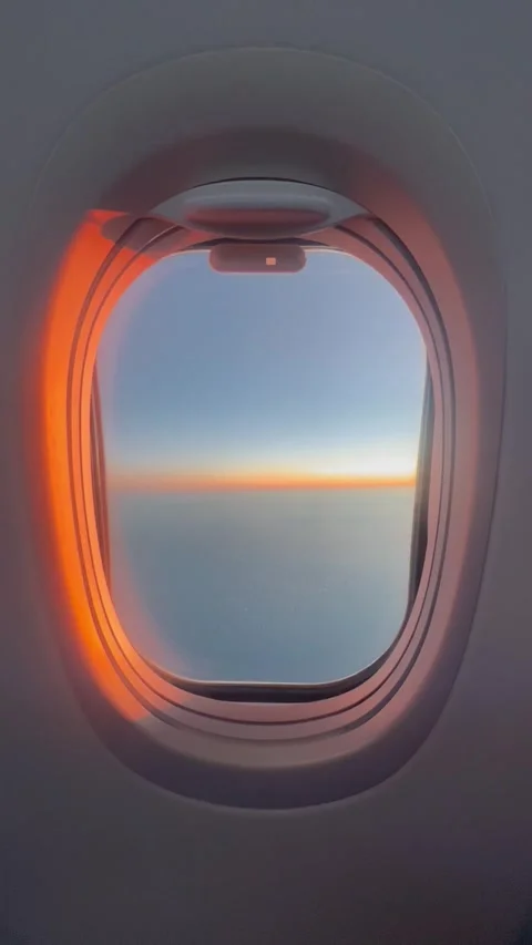 View of plane window by sunset during flight Stock Footage 334445506