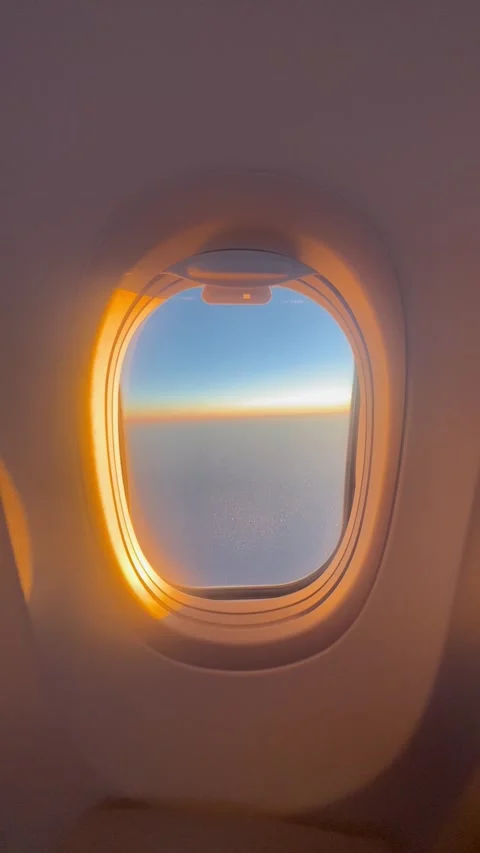 View of plane window by sunset during flight Stock Footage 334445534