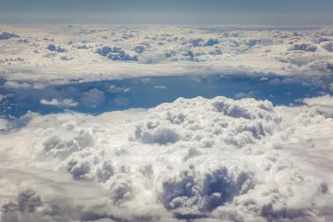 View from plane window on a white cloudscape durin flight Stock Photos
