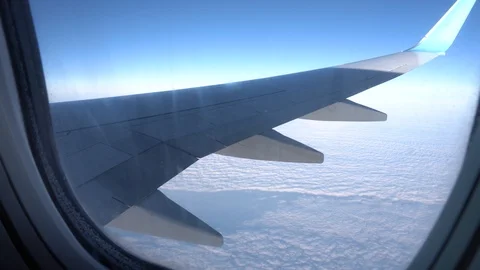 View from the plane window. Wing and sky in the window of the plane Stock Footage 120804364