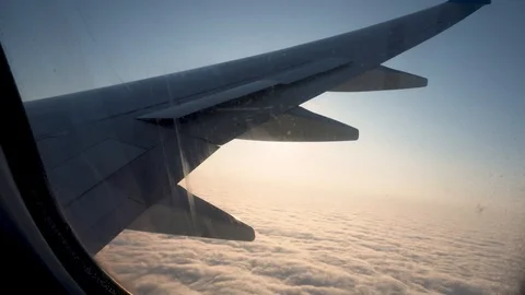 View from the plane window. Wing and sky in the window of the plane Stock Footage 120804400