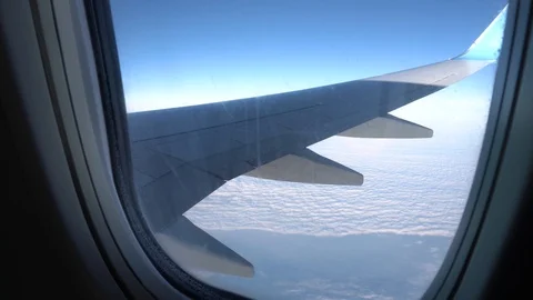 View from the plane window. Wing and sky in the window of the plane Stock Footage 120804416