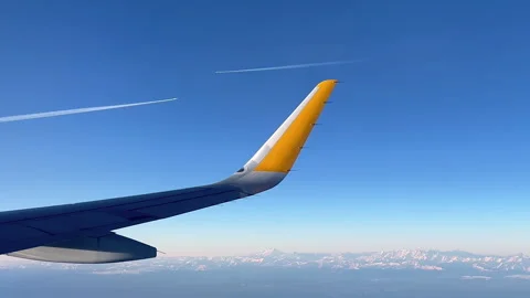 View from plane window on wing, two white airplane traces against the sky Video stock 251325389