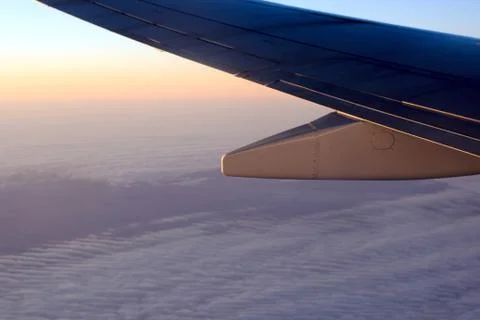 View of the plane wing and clouds from the plane window Stock Photos