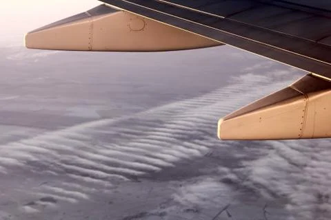 View of the plane wing and clouds from the plane window Stock Photos