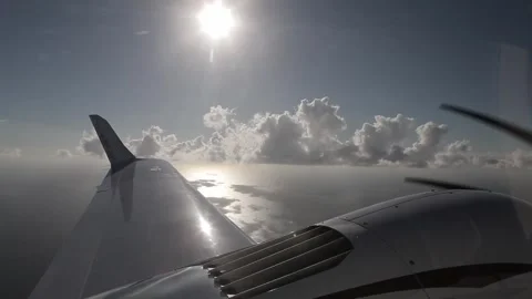 View of plane wing flying over the sea Stock Footage 260578368