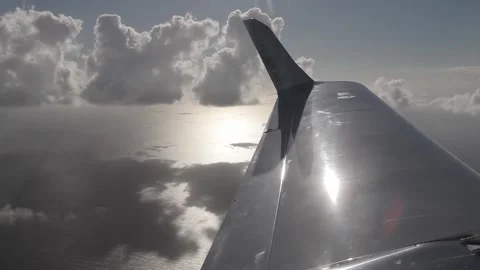 View of plane wing flying over the sea Stock Footage 260578371