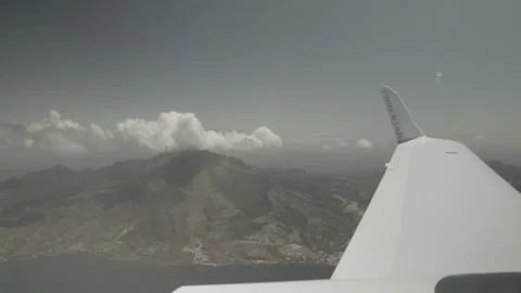 View of plane wing flying over the sea Stock Footage 260578387