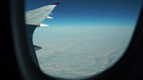 View from plane wing: large expanse of snowy landscape Stock Footage 235650481