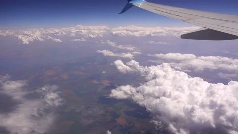 View of plane wing through an airplane window in flight trip, Video stock 136388174