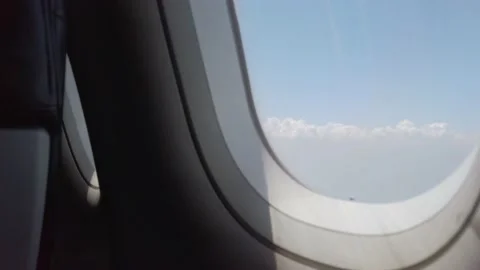 View of the plane wing through the airplane window. Air Transportation Stock Footage 202109115