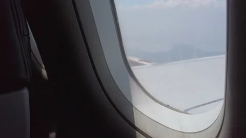 View of the plane wing through the airpl... | Stock Video | Pond5