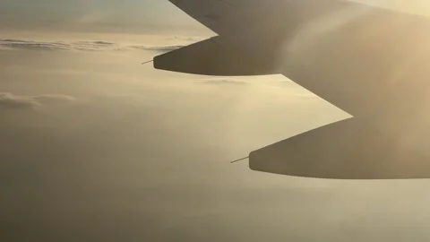 View of Plane Wings, Sky, and Clouds from Plane Window Stock Footage 214220116