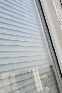 View of a plastic window from the outside. Blinds on a plastic window. Sele.. Stock Photos