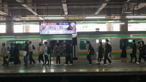 View to platform of JR local train station while crowded passenger just got.. Stock Footage 321289350