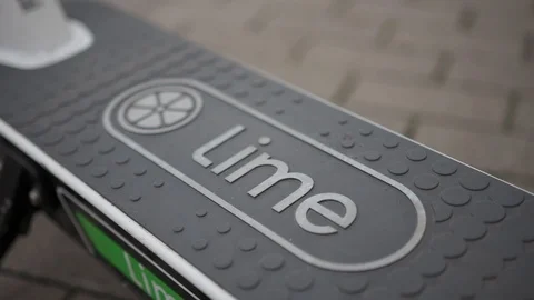 View of the platform of a Lime electric scooter on a pavement in the city Stock Footage 117915185