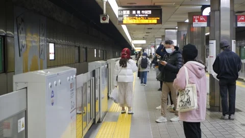 View at platform train station with passenger waiting for arriving approach.. 動画素材 323915961