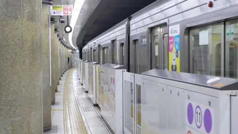 View at platfrom area inside Nagoya Subway station while train leaving depa.. Video stock 297451099