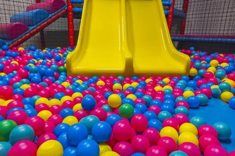 View of playing in pool with plastic balls and slide on indoor playground. Stock Photos