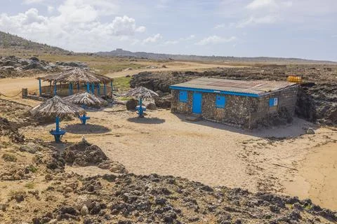 View of plot with abandoned stone house in desert on Caribbean sea coast Fotos de archivo