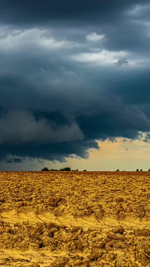 View of a plowed field under a dramatic stormy sky in Latvia. Stock Footage 339951346