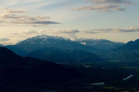 View point from cliff above valley with mountains and clouds. Stock Photos