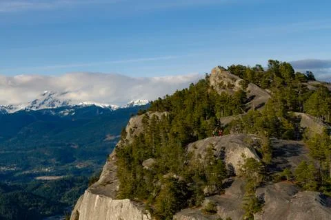 View point from cliff above valley with mountains and clouds. Stock Photos