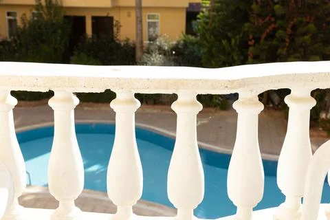 View of the pool through the balusters of the balcony Stock Photos