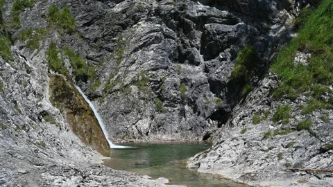 A view of a pool with a waterfall in the mountains Stock-Footage 219637057