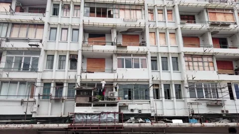 View of poorly maintained apartment building pan from left to right 4k Stock Footage 156324196