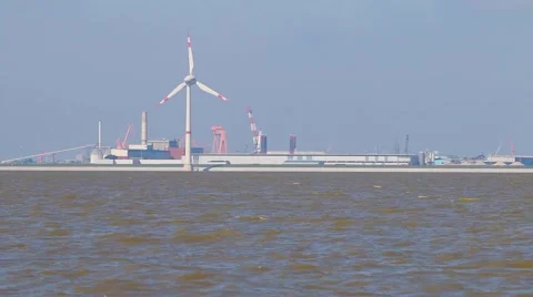 View at the port of Emden in Germany with a wind turbine in the foreground Stock Footage 48249204