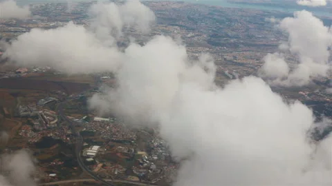 View from the porthole of an airplane. Clouds over Lisbon. Stock Footage 119213739