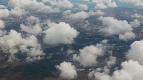 View from the porthole of an airplane. Clouds over Lisbon. Stock Footage 119323490