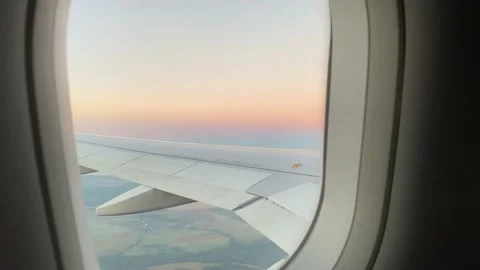 View from the porthole flight by plane sunset from the porthole Video stock 232169066