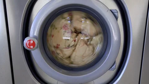 View of the porthole of the washing machine  during washing in laundry Stock Footage 251791016