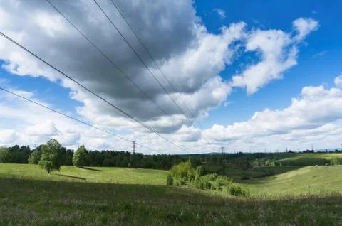 View of a power line with clouds floating over it Foto stock