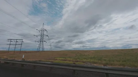 View of power lines while driving in remote eastern Oregon Stock Footage 312293102
