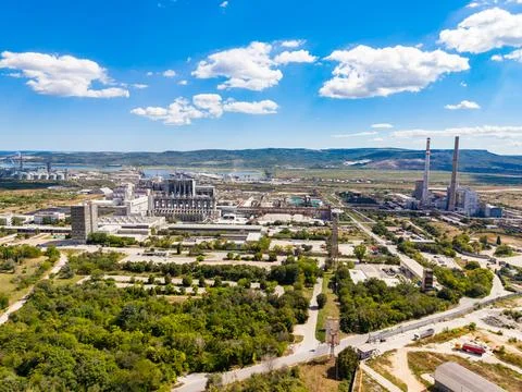 A view of a power plant complex is shown from above. The site is surrounded b Stock Photos