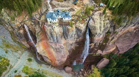 View of power station at top of cliffs with waterfalls Fotos Stock