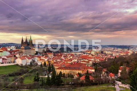 View of Prague and Prague castle from Petrin hill at sunset with dramatic s.. Stock Photos