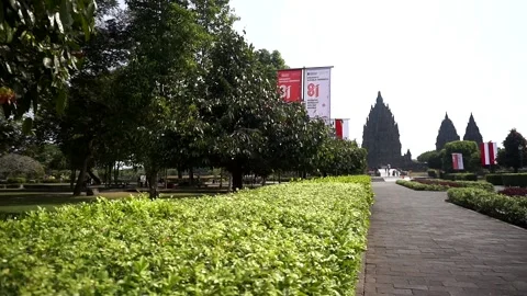 View of Prambanan Temple decorated with red and white banners along the park Stock-Footage 342689276