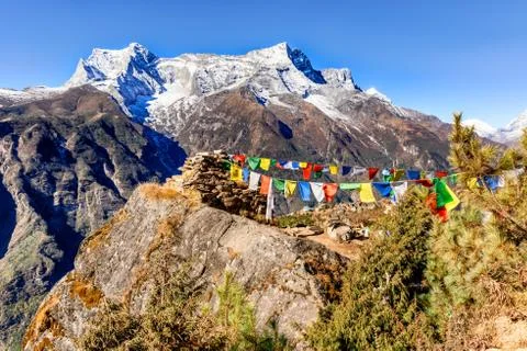 View at the prayers flags and Kongde Ri peak on the trek to Everest base camp Stock Photos