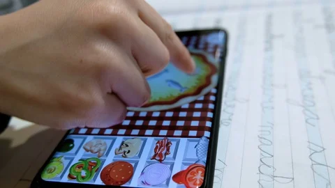 View of preschool kid playing mobile game on smartphone, kids education family Vidéo 128384544