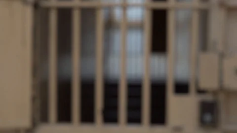 View of the prison corridor through the bars on the door. Stock Footage 124437814