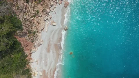 View of pristine beach with rocks and blue water Stock-Footage 251661601
