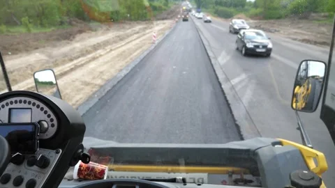 View on process of roadwork from inside cabin of steamroller. Roller laying new Stock Footage 335817944