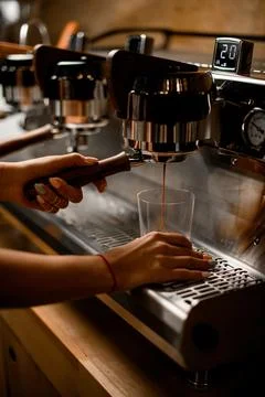 View of professional coffee machine with which barista woman prepares coffee Stock Photos