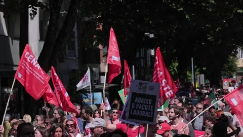 View of protesters with red flags during a labor union march, Portugal. Video stock 335026723