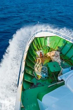 View of prow of ship hitting wave on open sea Stock Photos