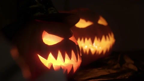 View of pumpkins with carved faces and lights inside for Halloween celebration Stock Footage 217368841